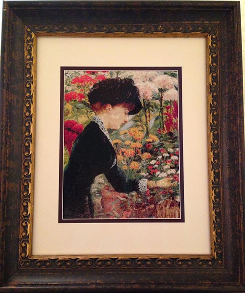 cross stitched picture of woman with flowers